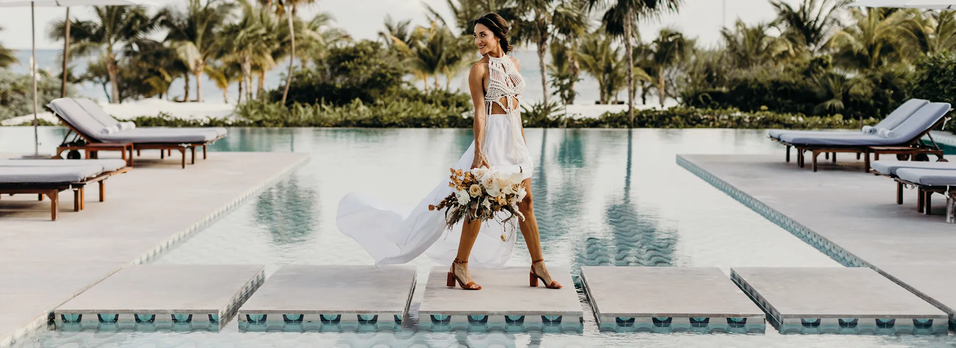 A woman standing in front of a swimming pool, a marble sculpture by Maud Naftel, unsplash contest winner, private press, pixel perfect, made of flowers, rich color palette
